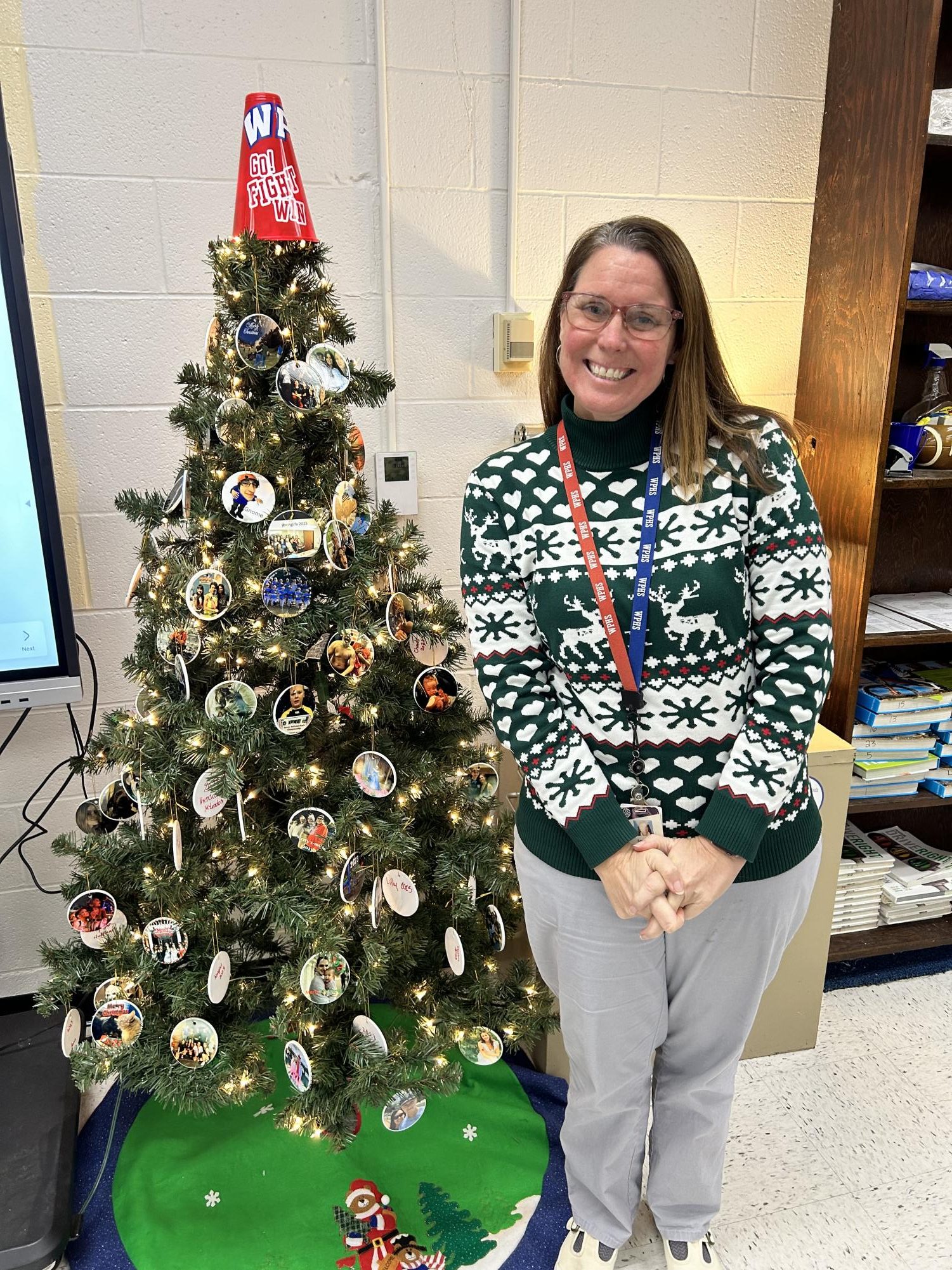 Mrs. Goodrich with her Christmas tree decorated with ornaments made by her students!