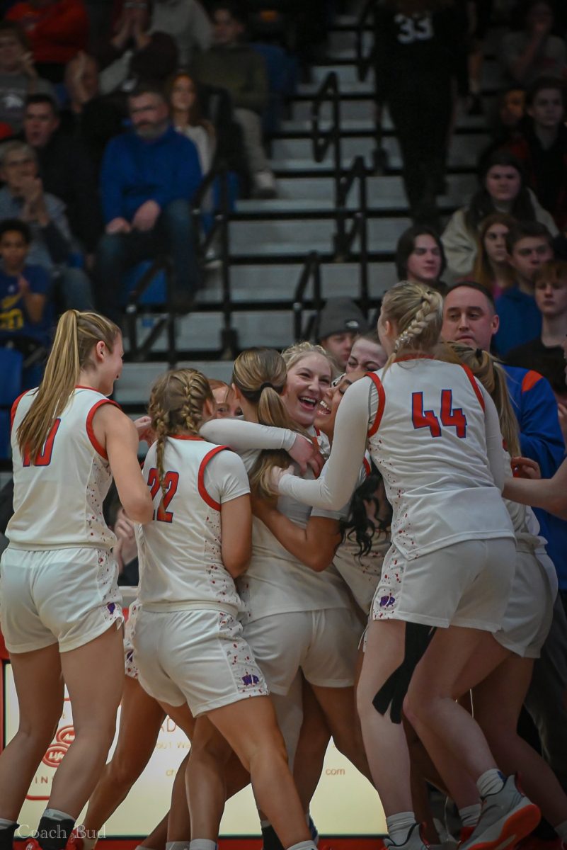 Girls Basketball Team celebrates as Lala Woods surpasses 1,000 points scored. 