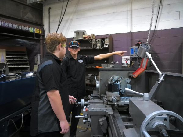 Two students using a lathe machine in Parks state-of the art shop