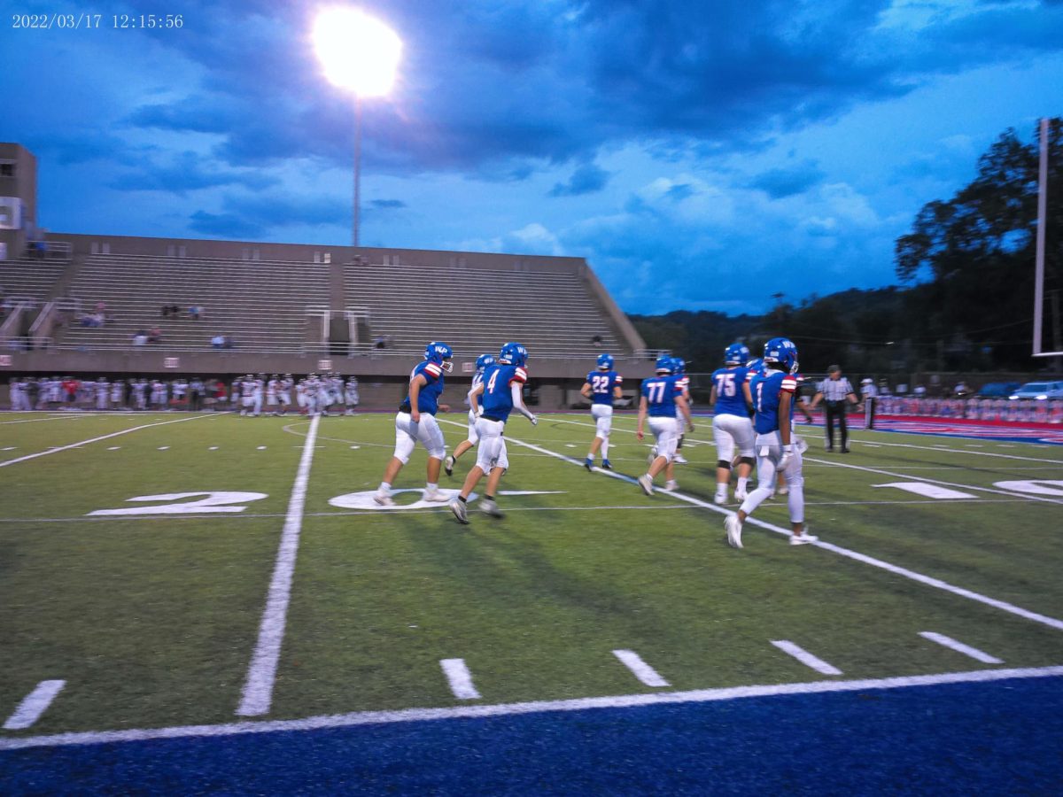 Brennan Wack, #4, runs on to the field.