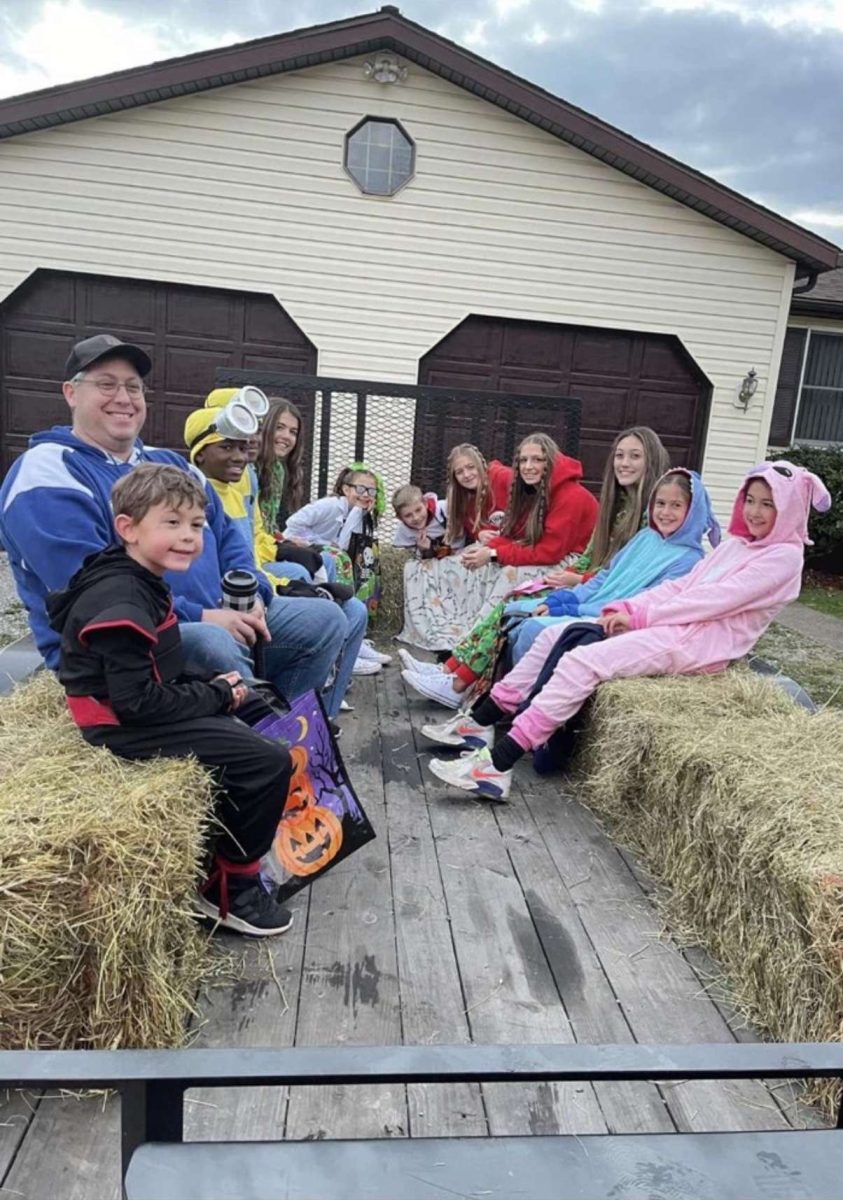 Teens and kids trick or treating together on Halloween in 2021.