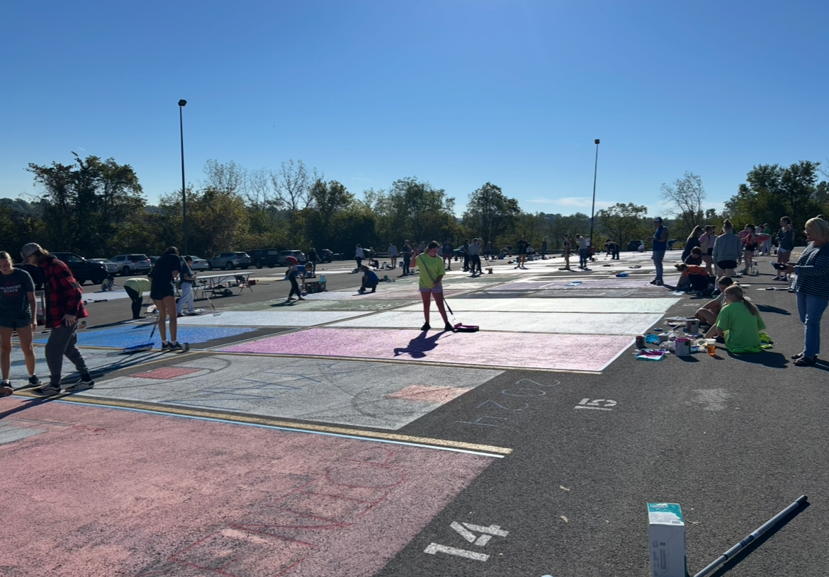 Seniors work throughout the lot to personalize a piece of their school.