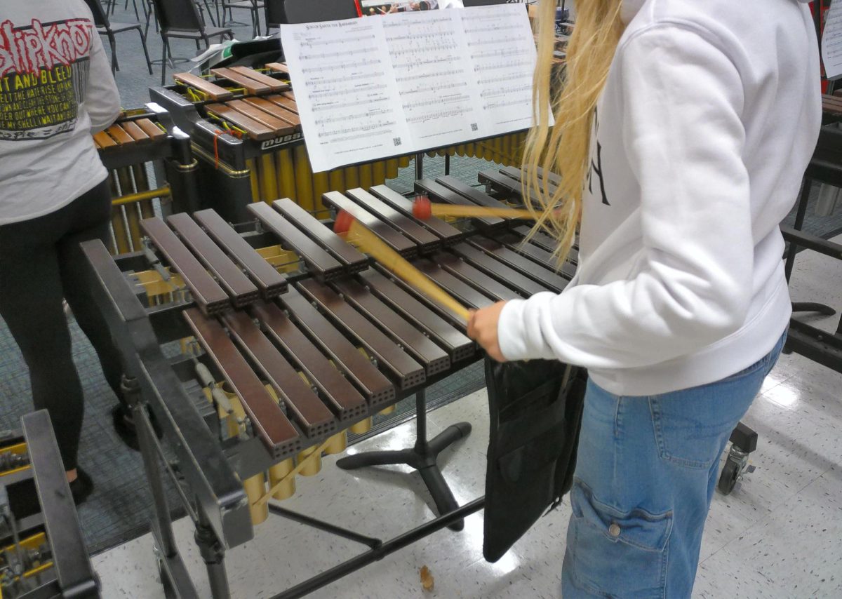 Band students practice independently before putting everything together with strings and choir.