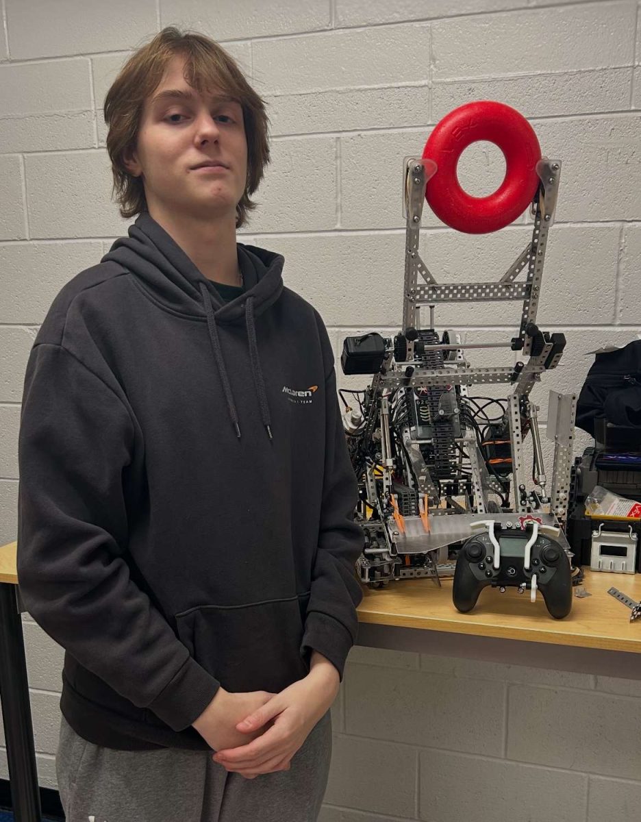 Wyatt is posing in front of his tournament ready robot