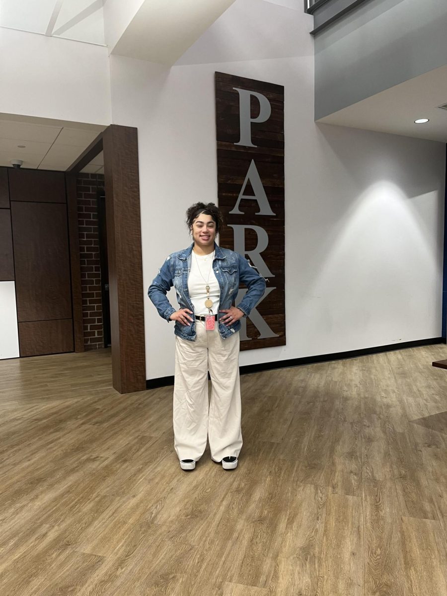 Mrs. Murphy stands outside of the Student Management office where her office is located. 