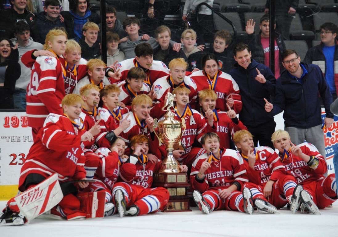 The hockey team posing for a picture in front of the student section after winning the state championship. 

Courtesy of Luke Simonetti