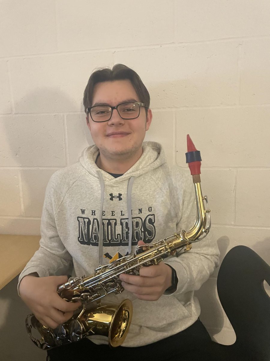 Anthony posing with his saxophone 