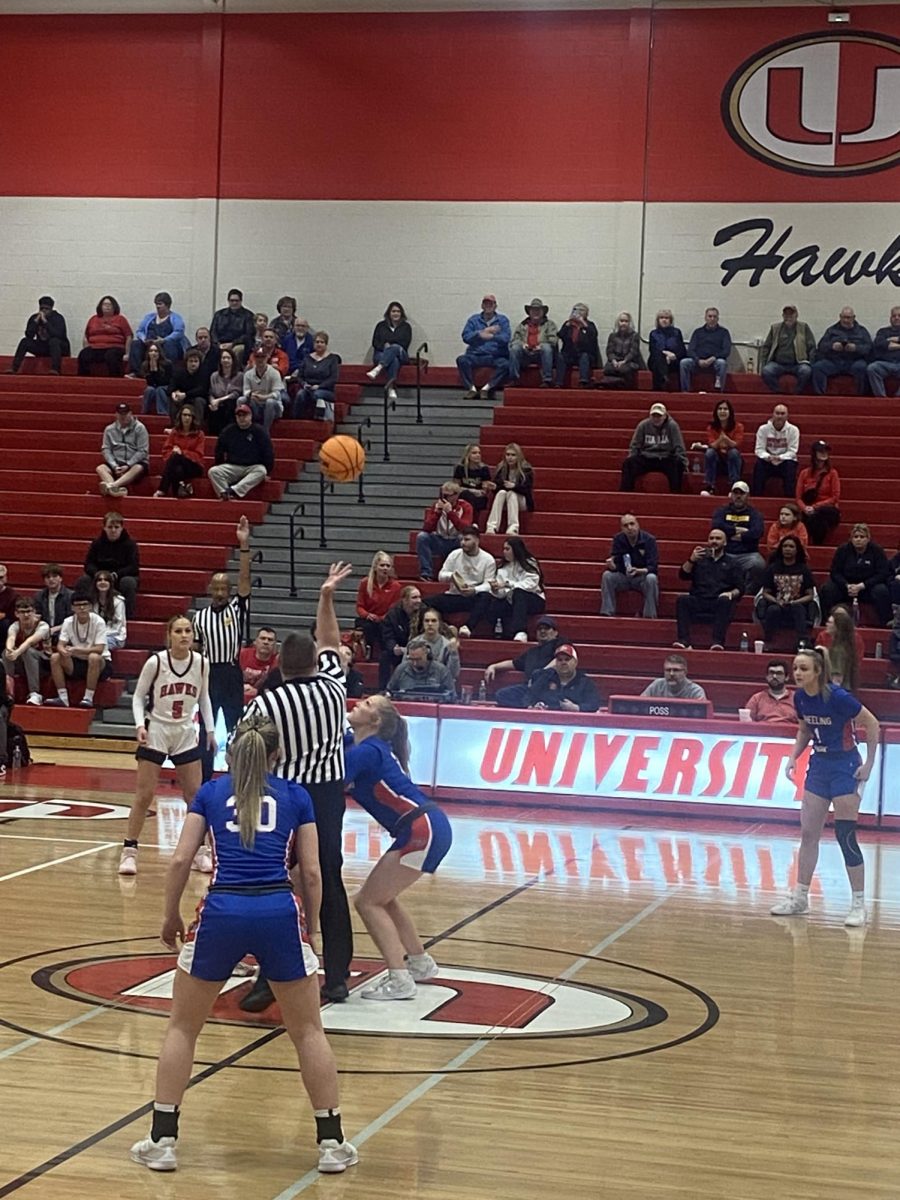 The referee tosses the jump ball between University and our Patriots in the region 1 co-final. 