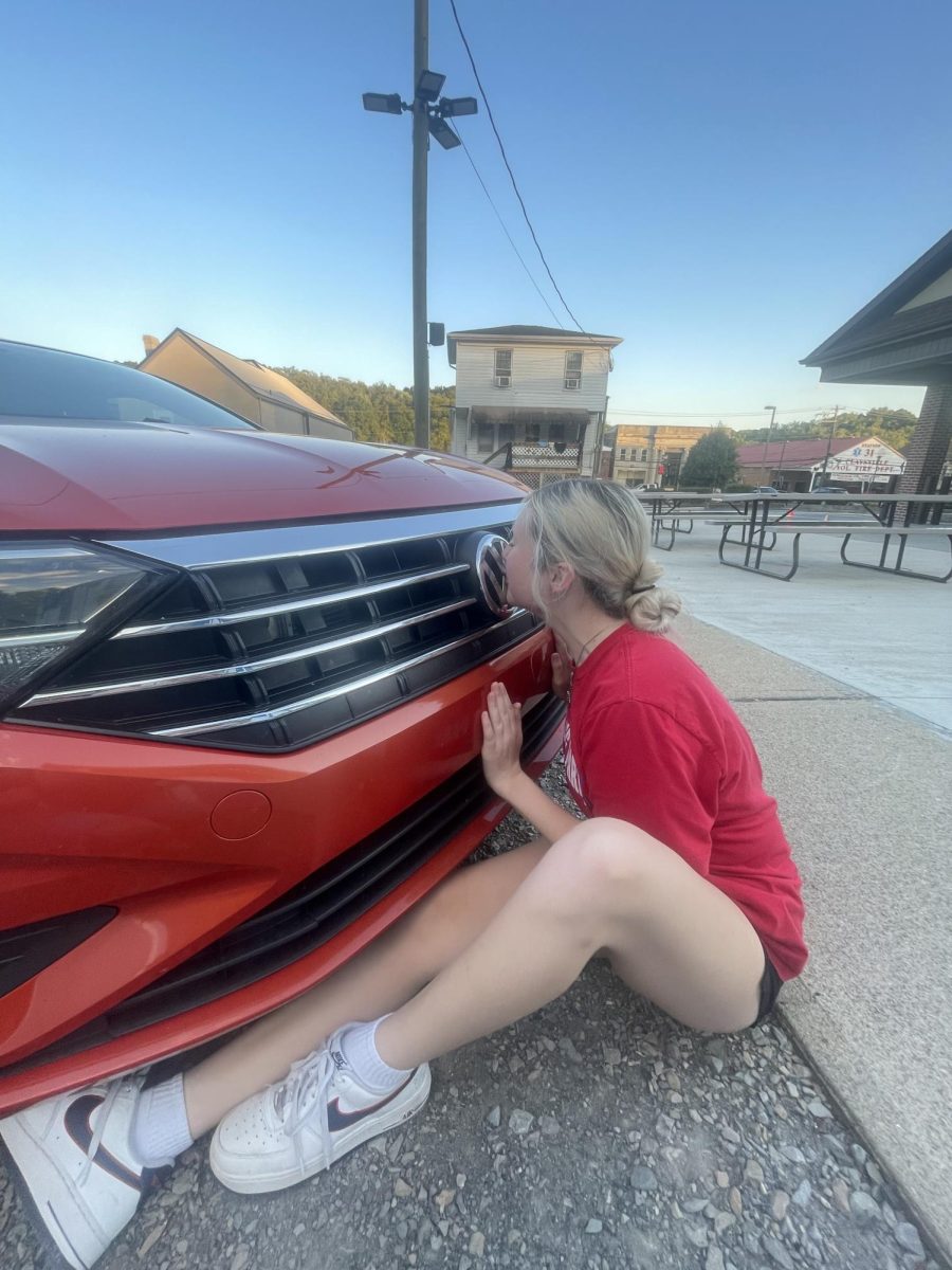 Kelsey and her beloved orange car. 