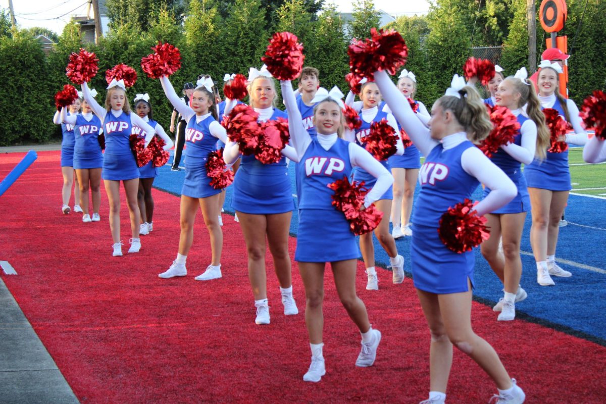 Cheerleaders cheer towards the student section during Friday's home game against Parkersburg South. 