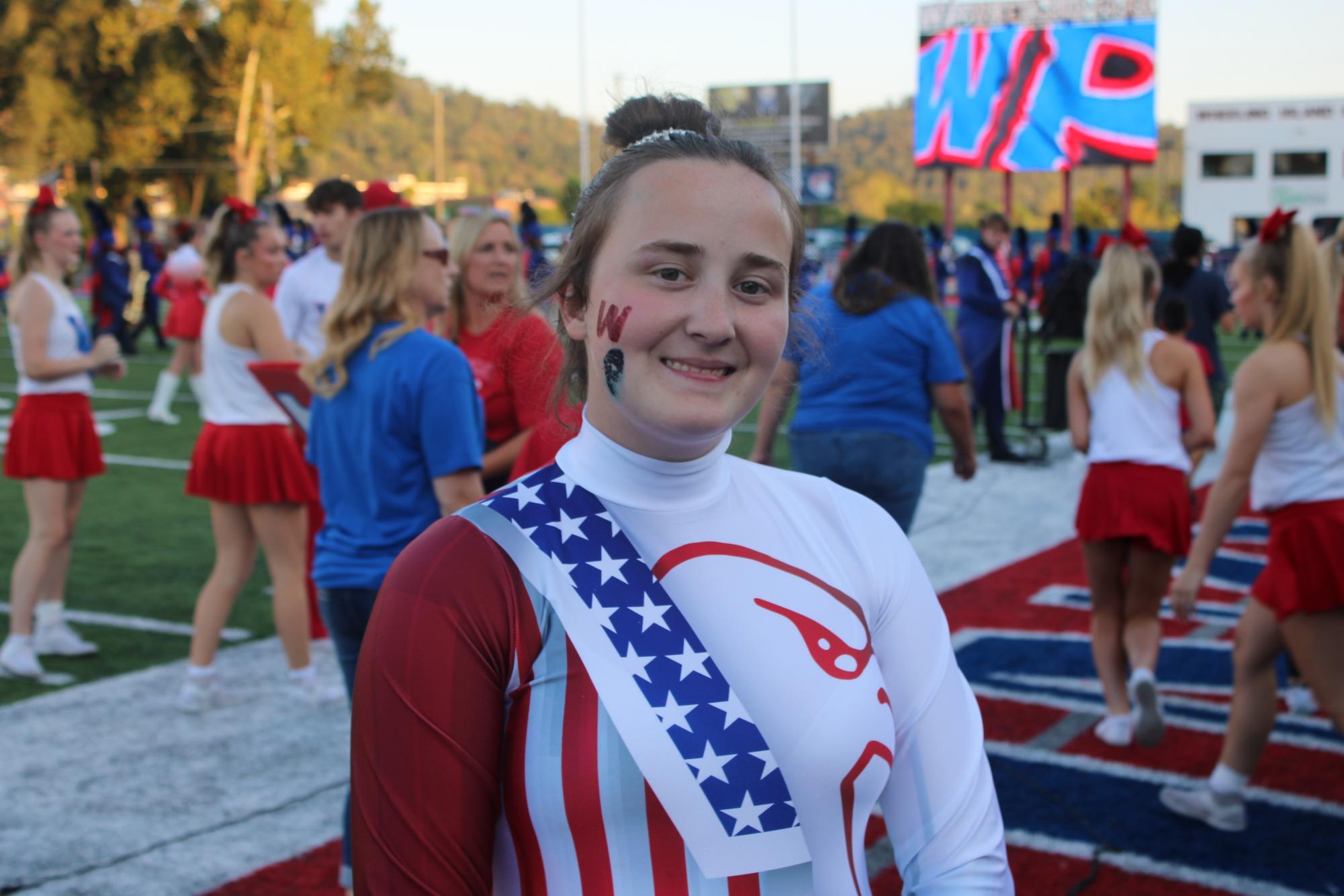 Amy Yahn kicks off the football game.
