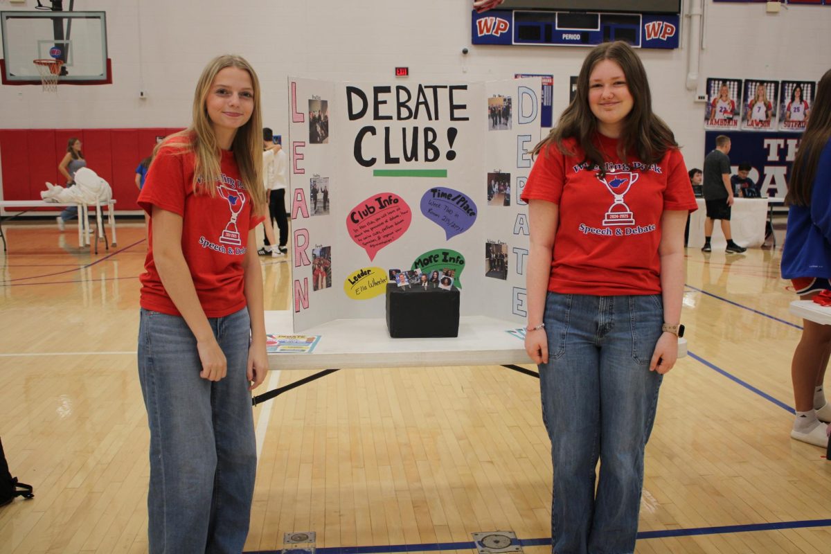 Ella Wheeler and Jo Gilbert debate kids on why they should join the Debate Club.