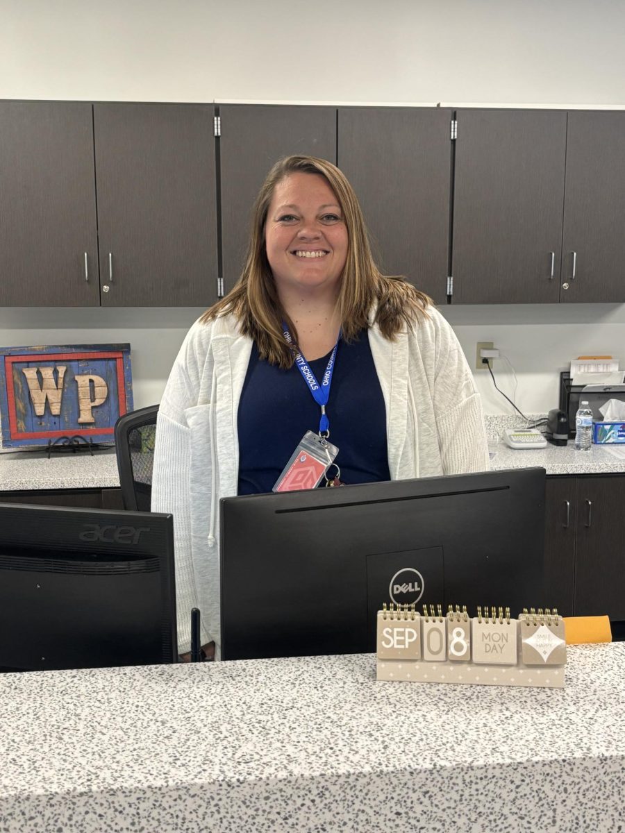 Ms. Blake, main office secretary, greets hundreds of students and teachers every day. 