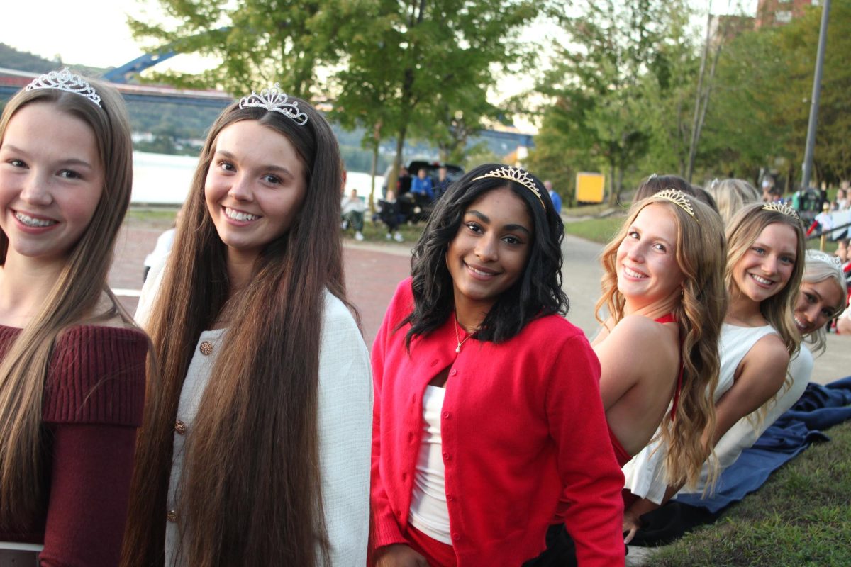 Queen candidates await the crowning of the king.