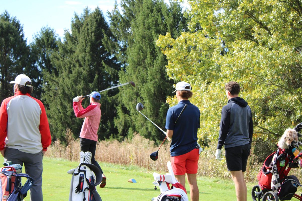 WPHS Golfers watch as Pennybacker swings his shot.