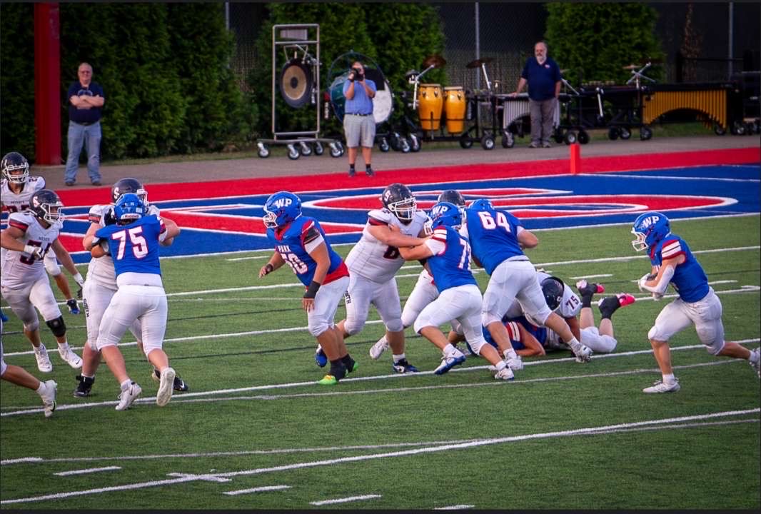 Brennan Wack(4) rushing behind his linemen, Kameron Dietrich(74), Kayden Fortney (64),
Carson Mccort (72), Liam Waldeck (75), Reuben Rouse (50), as he scores a touchdown. 