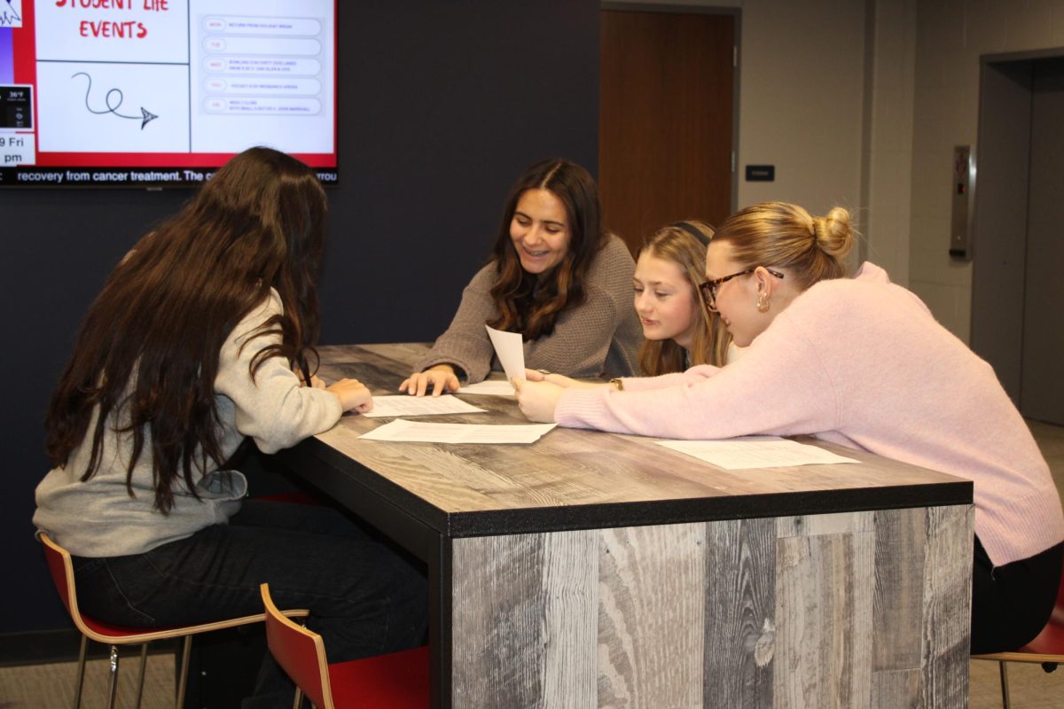 Amiah Fuentes works with students in the ILC on assignments that help students approach performing poetry pieces.