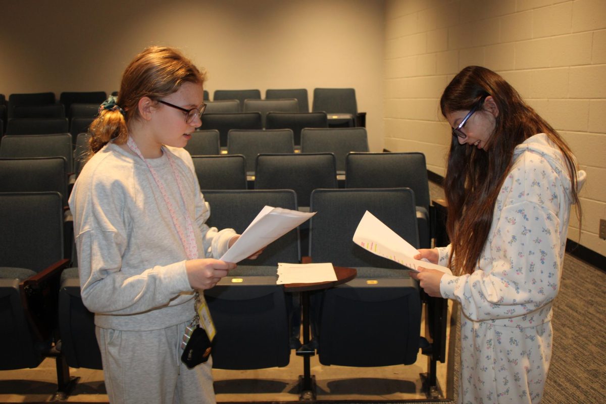 Middle school students practice their duo and work on their newly provided script.