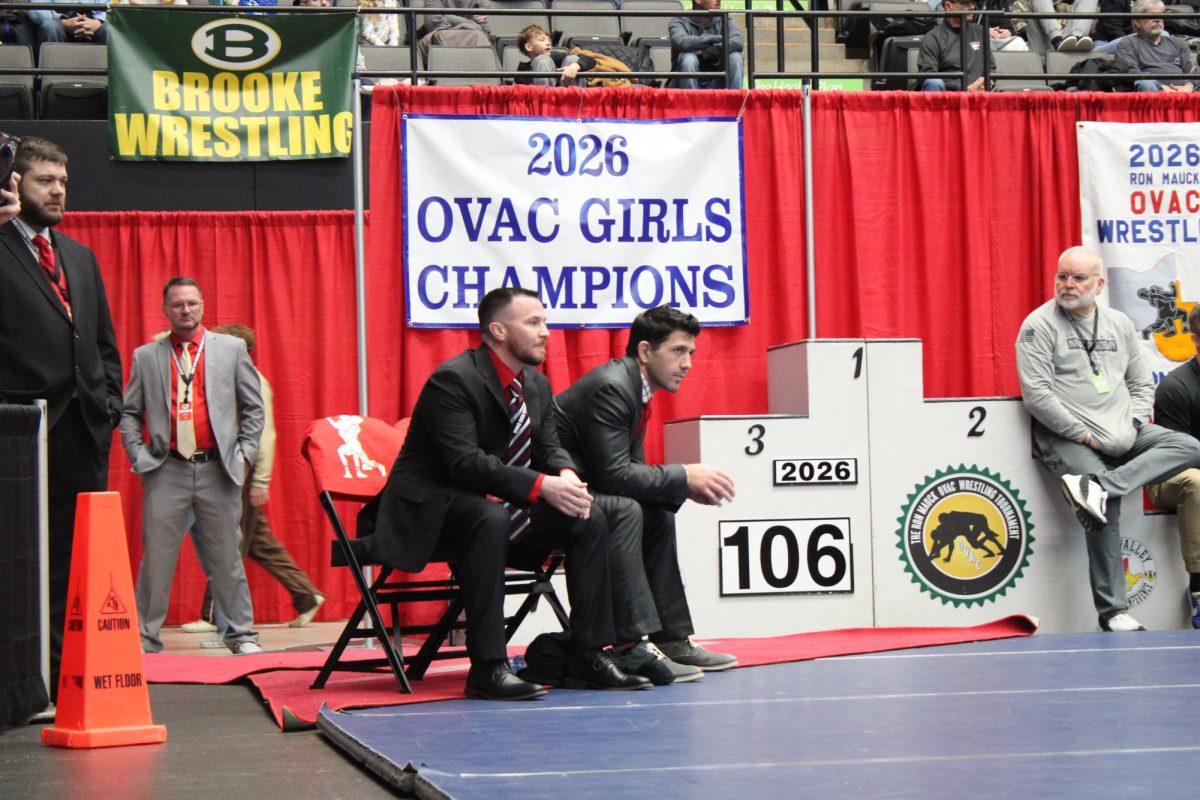 Coaches Bauer (L) and Doyle (R) watch the mat intently as their team competes. 