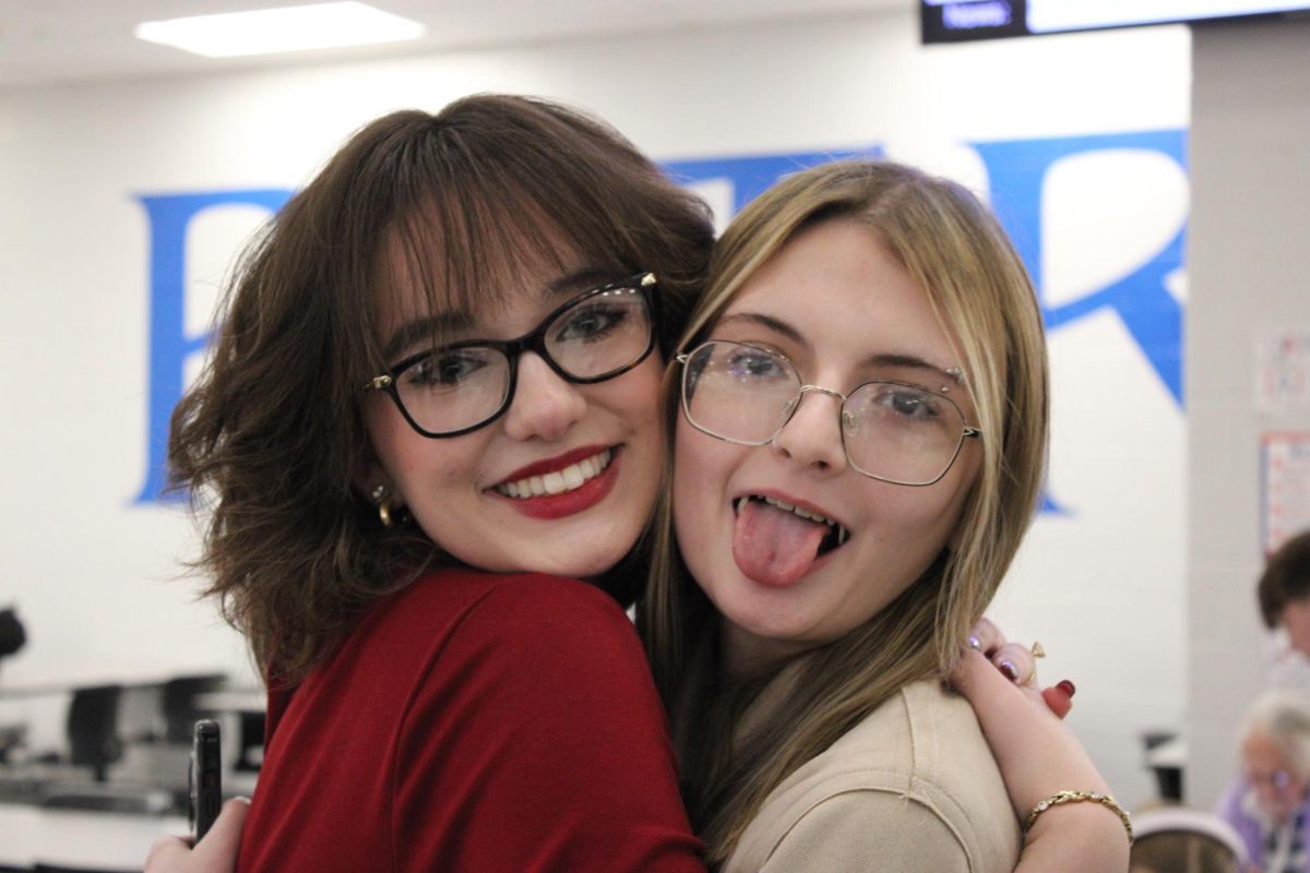 Jessamine Schmidt (right) hugging Jana Schodzinski (left)