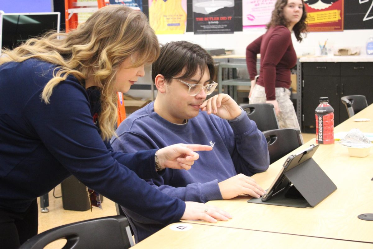 Ms Marshall assists Wyatt Rich in Studio 235, the graphic design studio at Wheeling Park.
