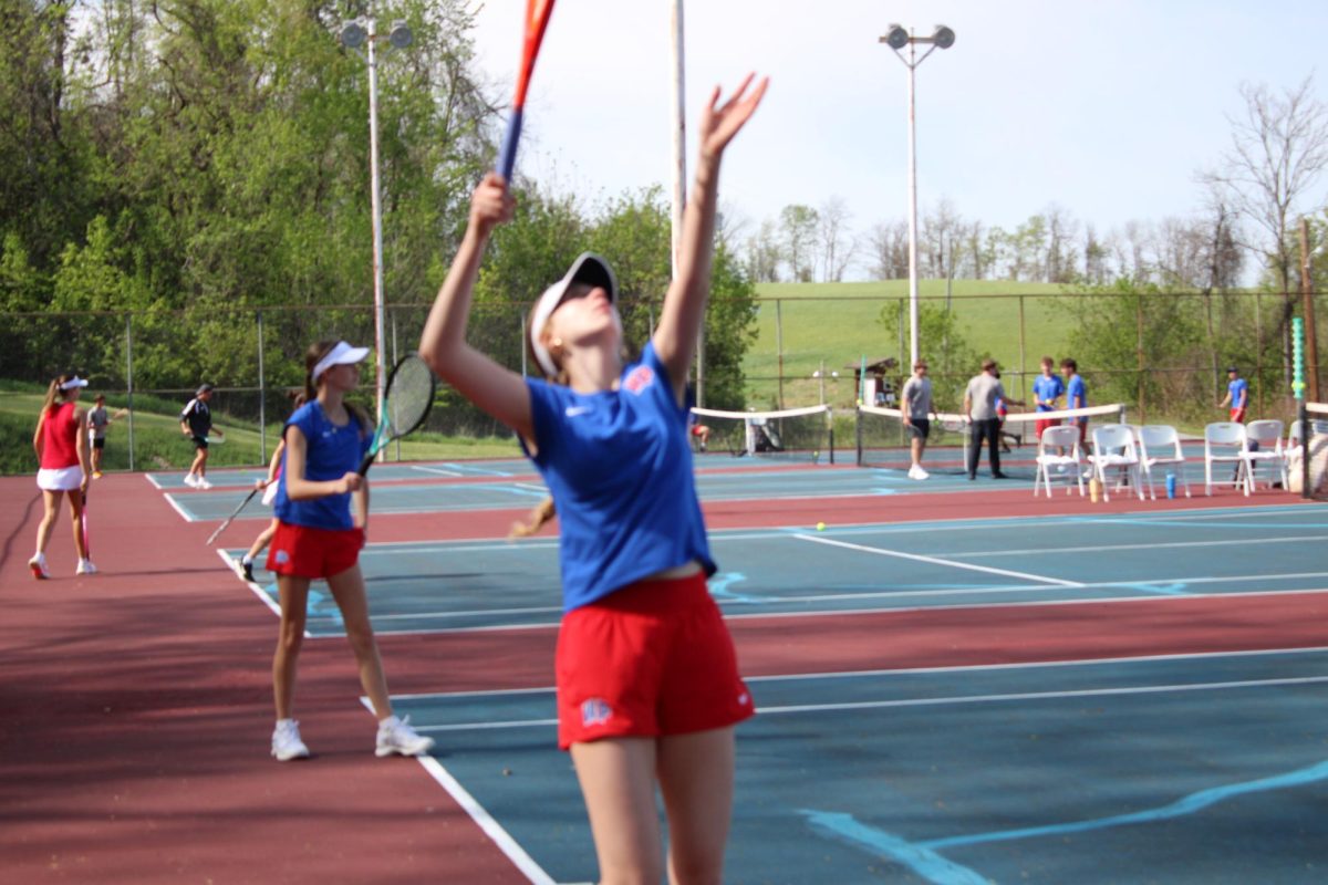 Madeline serves that ball as Sam stands ready. 