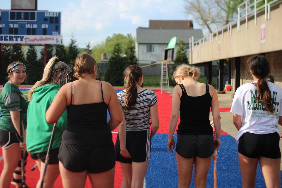 Rayven, Katelyn, Brooklyn, Olivia, Riley, and Ava walking into practice at the Island stadium.