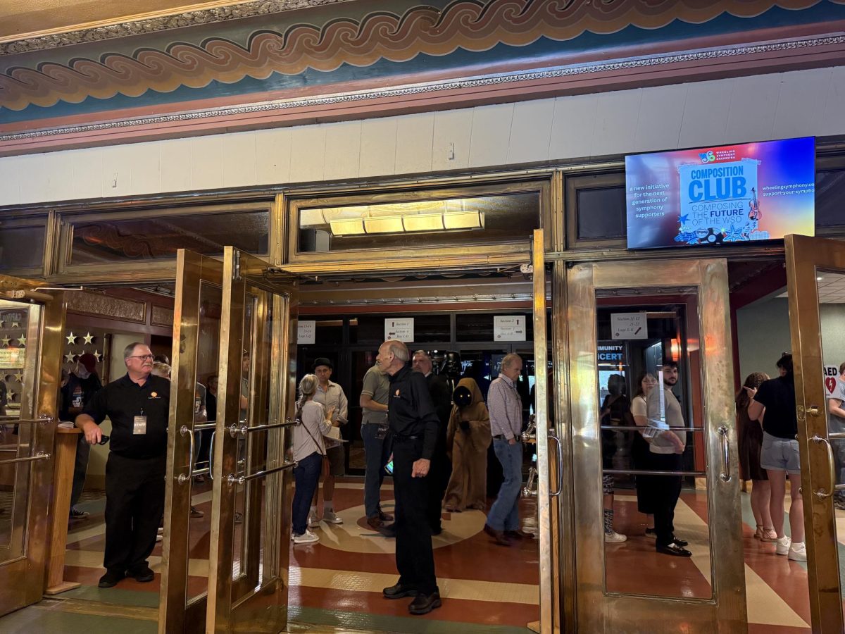 The crowd rolls in, creating a line that stretches around and outside the entrance of the theatre. Excitement from fans takes over. 