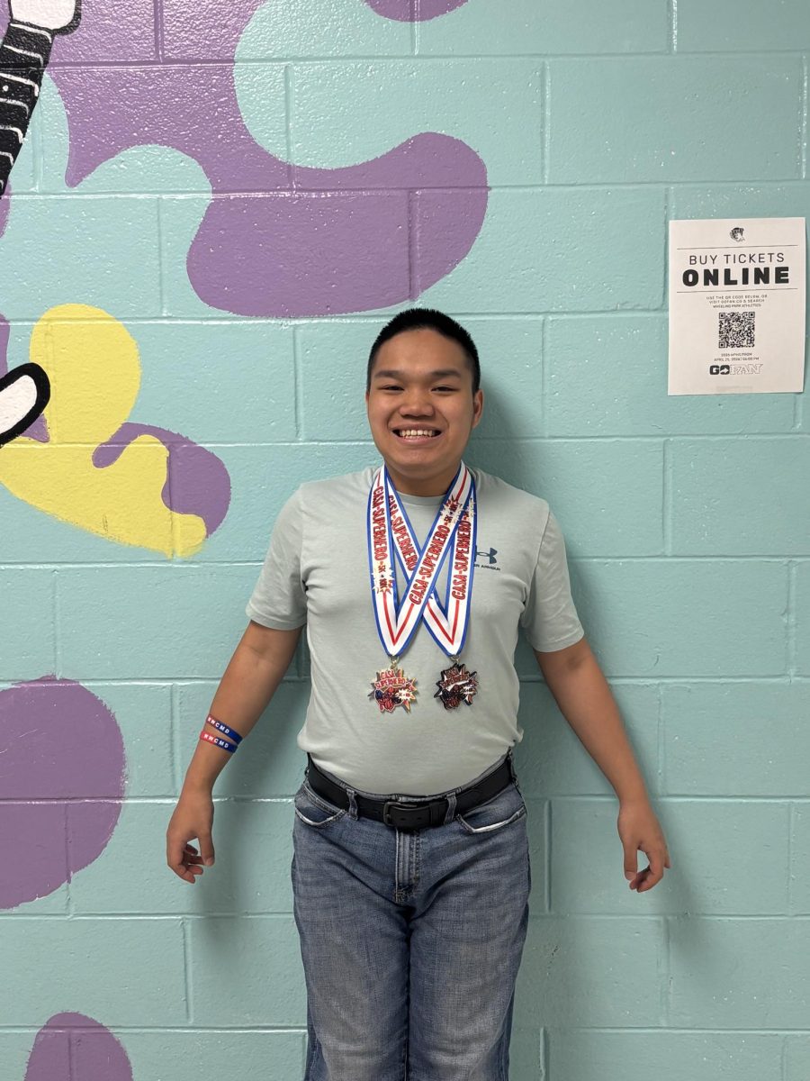 Michael with his first place medals outside one of his favorite classes, music!