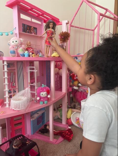 Cali getting ready to play with some Barbies and her Barbie Dreamhouse