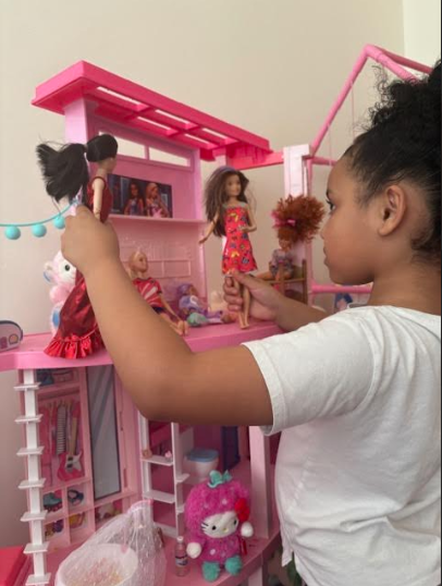 Cali de-stresses after a busy day at school by letting her imagination run wild with her dolls.