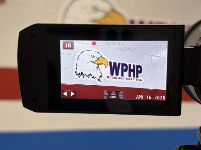 The shot of the WPHP sign outside of the Radio and TV room is centered, and Swiger is happy with the shot.