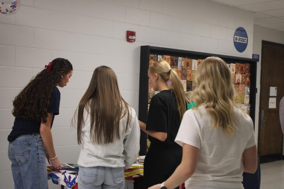 Everyone picks out what they want to take a picture with while Senior Class President, Taylin Holt, films them for her Decison Day post. 